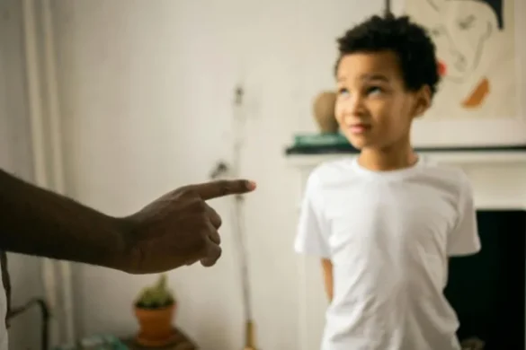 A parent scolds a child who appears upset.
