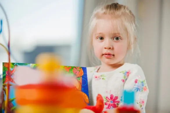 A toddler girl with blond hair and blue eyes